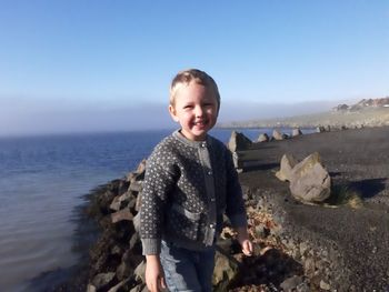 Portrait of boy standing at beach