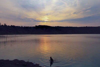 Scenic view of lake against sky during sunset