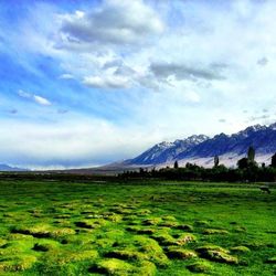 Scenic view of mountains against cloudy sky