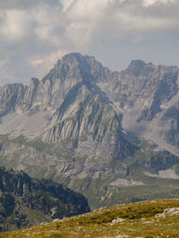 Scenic view of mountains against cloudy sky