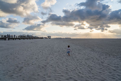 Scenic view of beach against sky during sunset