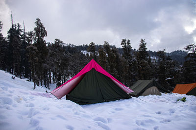 A campsite covered with snow on a himalayan mountain
