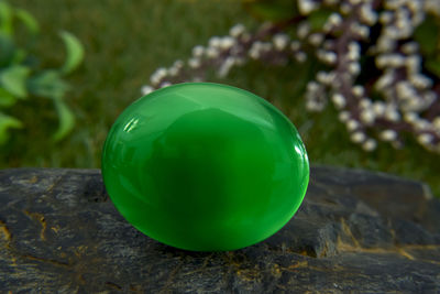 Close-up of multi colored ball on rock