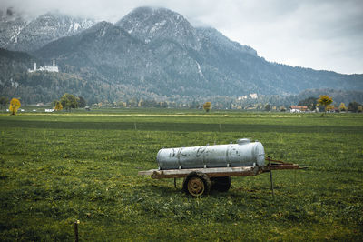 Tractor on field against mountain range