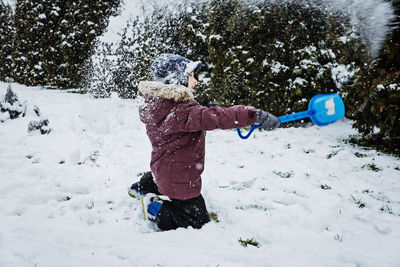 Outdoor winter activities for kids and family. let it snow. happy family mom and kid boy having fun