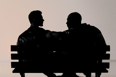 Rear view of silhouette man standing against sky during sunset