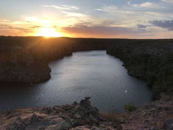 Scenic view of rocks against sky during sunset