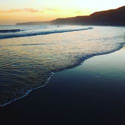 Close-up of sea against sky during sunset