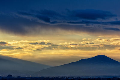 Scenic view of mountains against sky during sunset