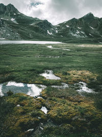 Scenic view of river and mountains against sky