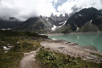 Scenic view of lake and mountains against sky