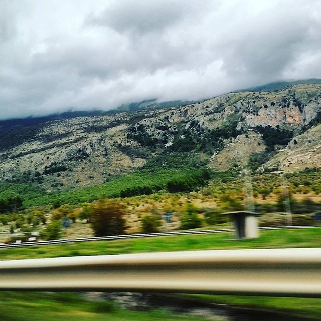 sky, cloud - sky, road, mountain, cloudy, landscape, cloud, transportation, tree, tranquil scene, nature, scenics, beauty in nature, green color, tranquility, weather, growth, country road, overcast, day