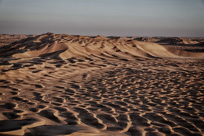 Sand dune in desert against sky