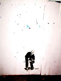 Man standing against wall