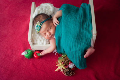 High angle view of baby sleeping in bed