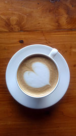 A cup of coffee latte with shaped heart cream