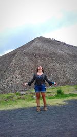 Full length of woman standing against sky