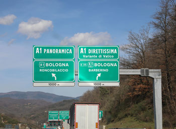 Italian traffic signs on the motorway called a1 with two roads panoramica or direttissima 