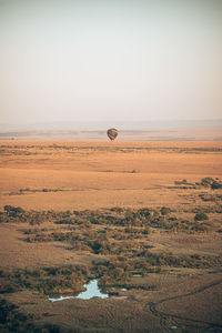 Hot air balloon flying over land