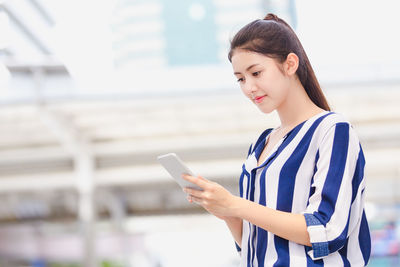 Young woman using mobile phone