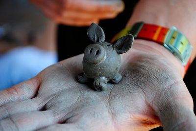 Close-up of hand holding small toy