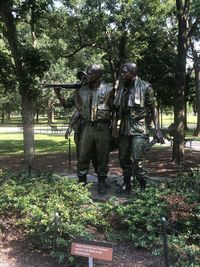 Rear view of people walking in park