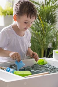 Portrait of cute boy drawing on table