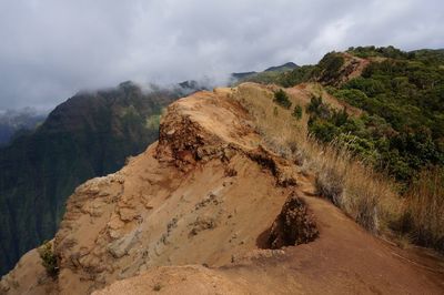 Scenic view of mountain cliff against sky