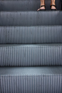 Low section of person on escalator