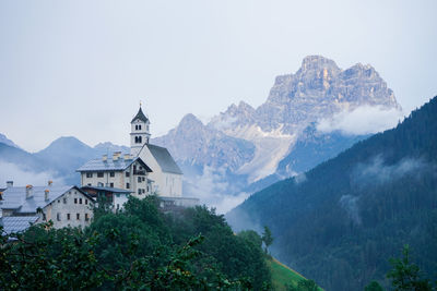 Panoramic view of buildings and mountains against sky