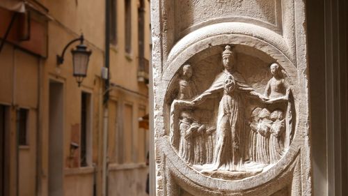 Close-up of statue against building