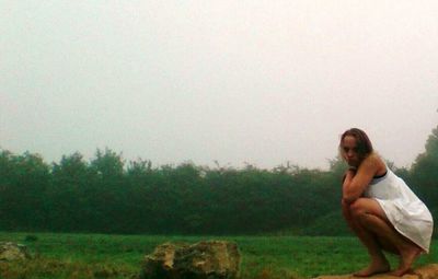 Woman standing on grassy field