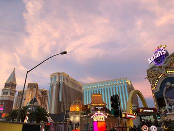 Low angle view of illuminated buildings against sky at dusk