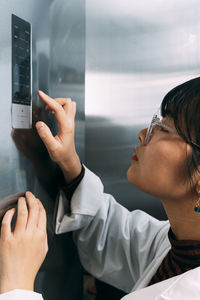 Young scientist using control panel