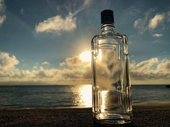 Water bottle on beach against sky