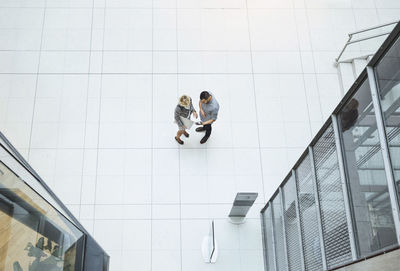 High angle view of business colleagues using digital tablet in modern office
