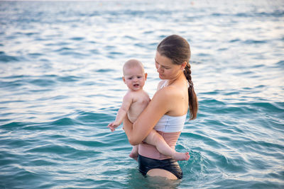 Mother with daughter in sea