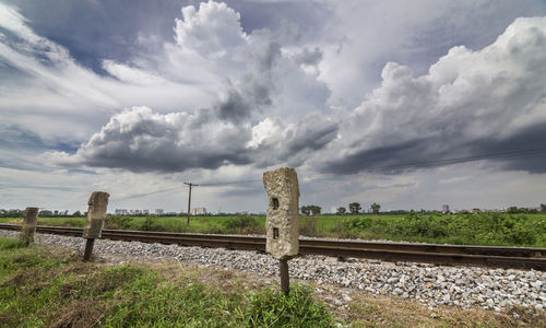 Railroad tracks on field against sky