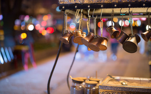 Containers hanging on concession stand at dusk