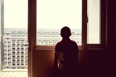 Woman looking through window