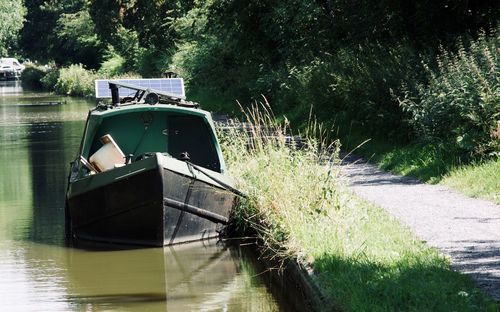 Boat moored on riverbank