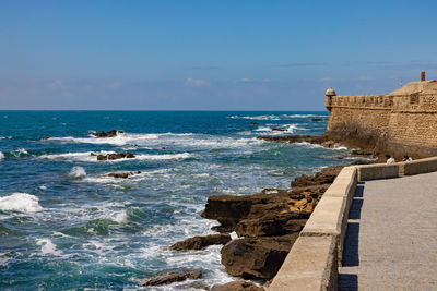 Scenic view of sea against sky with rocks