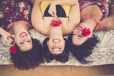 Portrait of young woman lying on floor