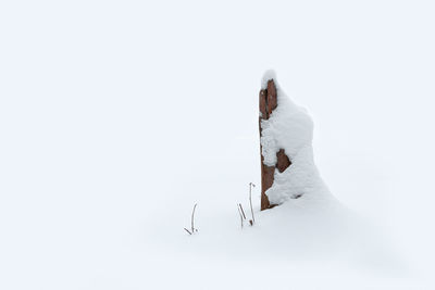 Scenic view of snow covered land against clear sky