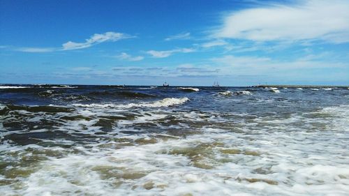 Scenic view of sea against blue sky