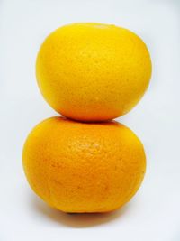 Close-up of orange apple against white background