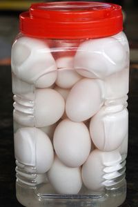 Close-up of eggs in glass jar on table