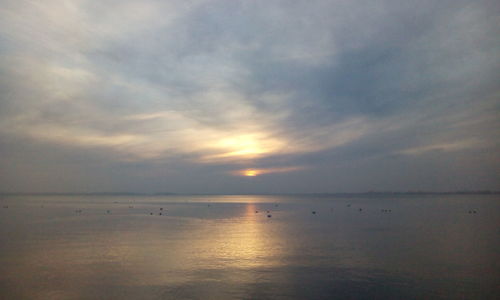 Scenic view of sea against cloudy sky