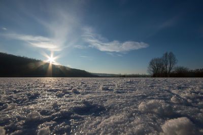 Scenic view of field against sky during winter