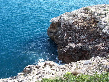High angle view of rock formation by sea
